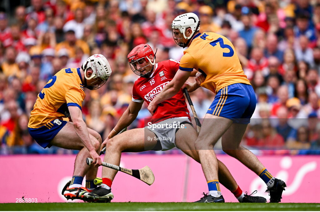 21 July 2024; Brian Hayes of Cork in action against Clare players Adam Hogan, left, and Conor Cleary during the GAA Hurling All-Ireland Senior Championship Final match between Clare and Cork at Croke Park in Dublin. Photo by Seb Daly/Sportsfile