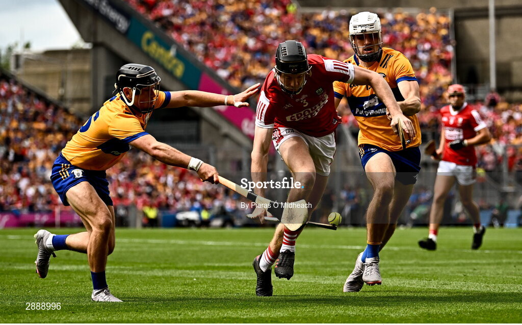 21 July 2024; Eoin Downey of Cork in action against Clare players David Reidy, left, and Aidan McCarthy of Clare during the GAA Hurling All-Ireland Senior Championship Final between Clare and Cork at Croke Park in Dublin. Photo by Piaras Ó Mídheach/Sportsfile