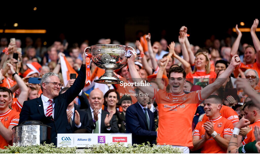 28 July 2024; Uachtarán Chumann Lúthchleas Gael Jarlath Burns and his son Jarly Óg Burns of Armagh lift the Sam Maguire Cup after Armagh's victory in the GAA Football All-Ireland Senior Championship Final match between Armagh and Galway at Croke Park in Dublin. Photo by Ramsey Cardy/Sportsfile