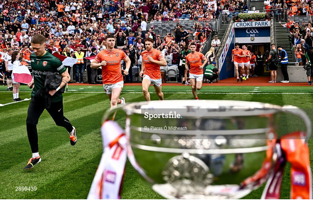 28 July 2024; Armagh players, Blaine Hughes, left, run onto the pitch past the Sam Maguire Cup before the GAA Football All-Ireland Senior Championship Final match between Armagh and Galway at Croke Park in Dublin. Photo by Piaras Ó Mídheach/Sportsfile