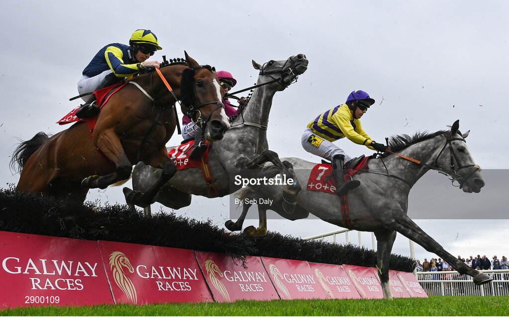 31 July 2024; Lightkeeper, left, with Jack Kennedy up, jumps the first alongside My Great Mate, centre, with Paul Townend up, and Gatito Rapido, right, with Jody McGarveý up, on their way to winning the Tote.ie Maiden Hurdle during day three of the Galway Races Summer Festival at Ballybrit Racecourse in Galway. Photo by Seb Daly/Sportsfile