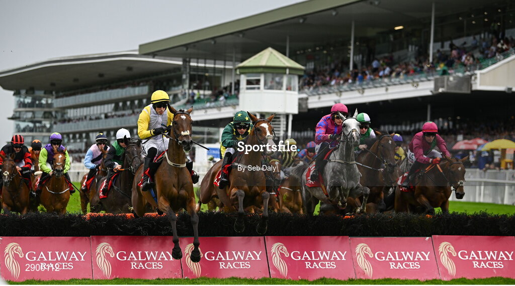 31 July 2024; Runners and riders jump the first during the Tote.ie Maiden Hurdle during day three of the Galway Races Summer Festival at Ballybrit Racecourse in Galway. Photo by Seb Daly/Sportsfile