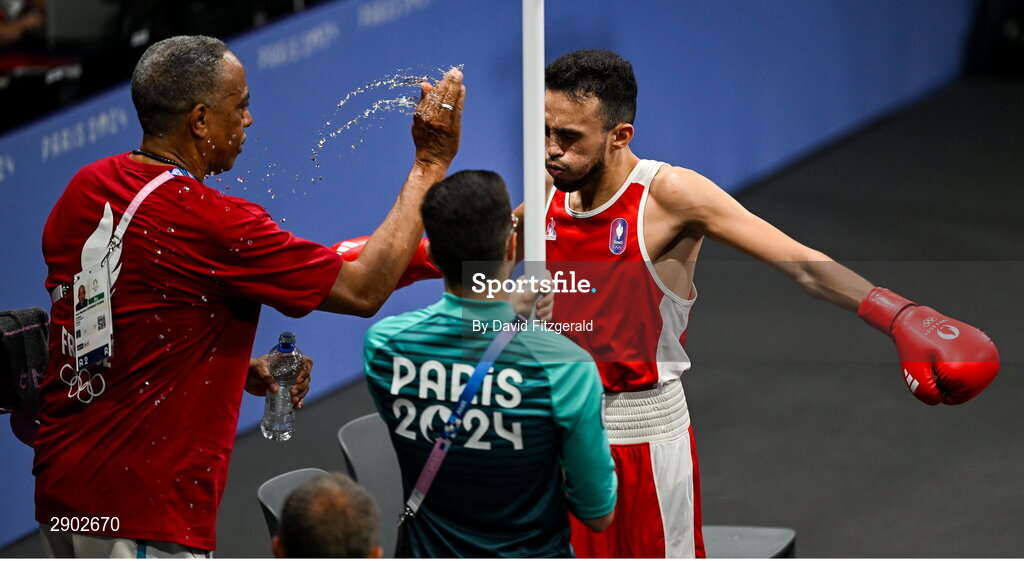 2 August 2024; Team France coach Luis Mariano Gonzalez Cosme splashes water on Billal Bennama of Team France before his men's 51kg quarterfinal bout against Alejandro Claro Fiz of Team Cuba at the North Paris Arena during the 2024 Paris Summer Olympic Games in Paris, France. Photo by David Fitzgerald/Sportsfile