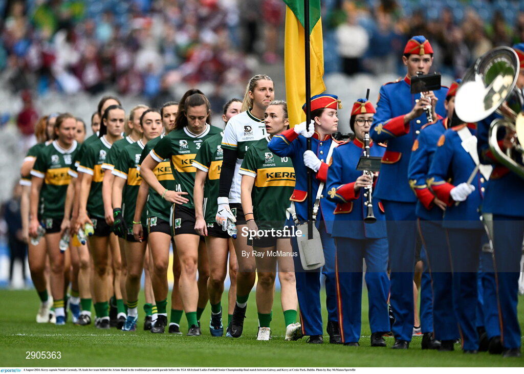 4 August 2024; Kerry captain Niamh Carmody, 10, leads her team behind the Artane Band in the traditional pre match parade before the TG4 All-Ireland Ladies Football Senior Championship final match between Galway and Kerry at Croke Park, Dublin. Photo by Ray McManus/Sportsfile