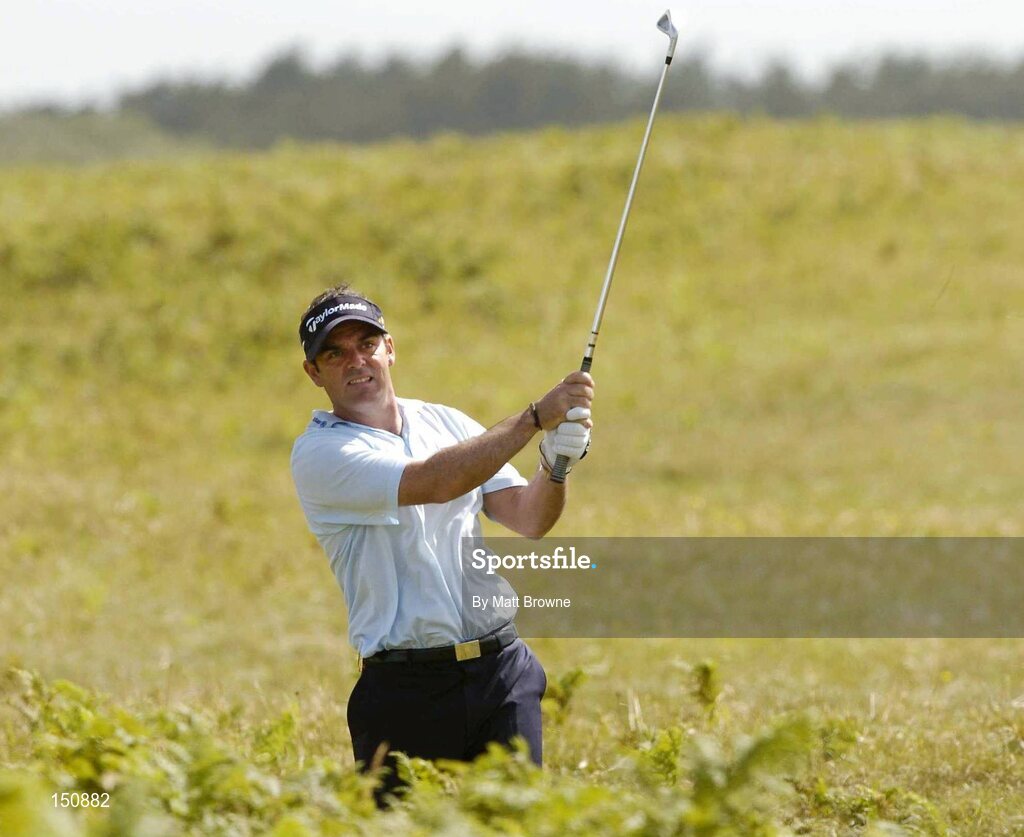 21 July 2004; Paul McGinley watches his second shot from the rough on the 6th fairway during the first round. Nissan Irish Open Golf Championship, County Louth Golf Club, Baltray, Co. Louth. Picture credit; Matt Browne / SPORTSFILE