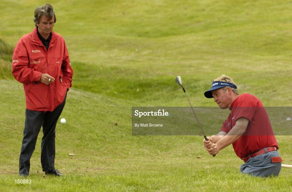 23 July 2004; Darren Clarke plays from a bunker under the supervision of his mental coach, Belgian, Jos Vanstiphout, before the start of the second round. Nissan Irish Open Golf Championship, County Louth Golf Club, Baltray, Co. Louth. Picture credit; Matt Browne / SPORTSFILE