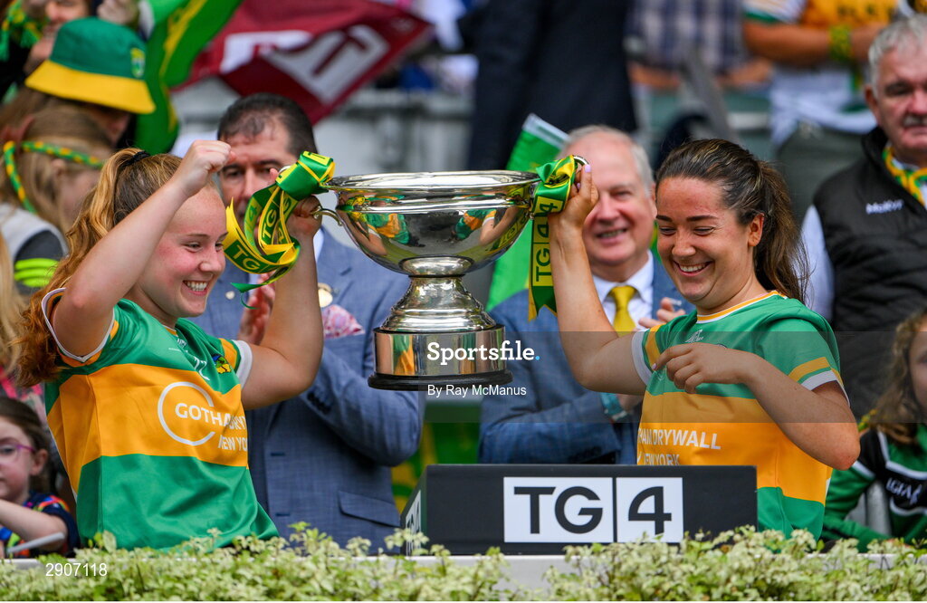 4 August 2024; Leitrim players Muireann Devaney and Leah Fox lift the Mary Quinn Memorial cup after the TG4 All-Ireland Ladies Football Intermediate Championship final match between Leitrim and Tyrone at Croke Park, Dublin. Photo by Ray McManus/Sportsfile