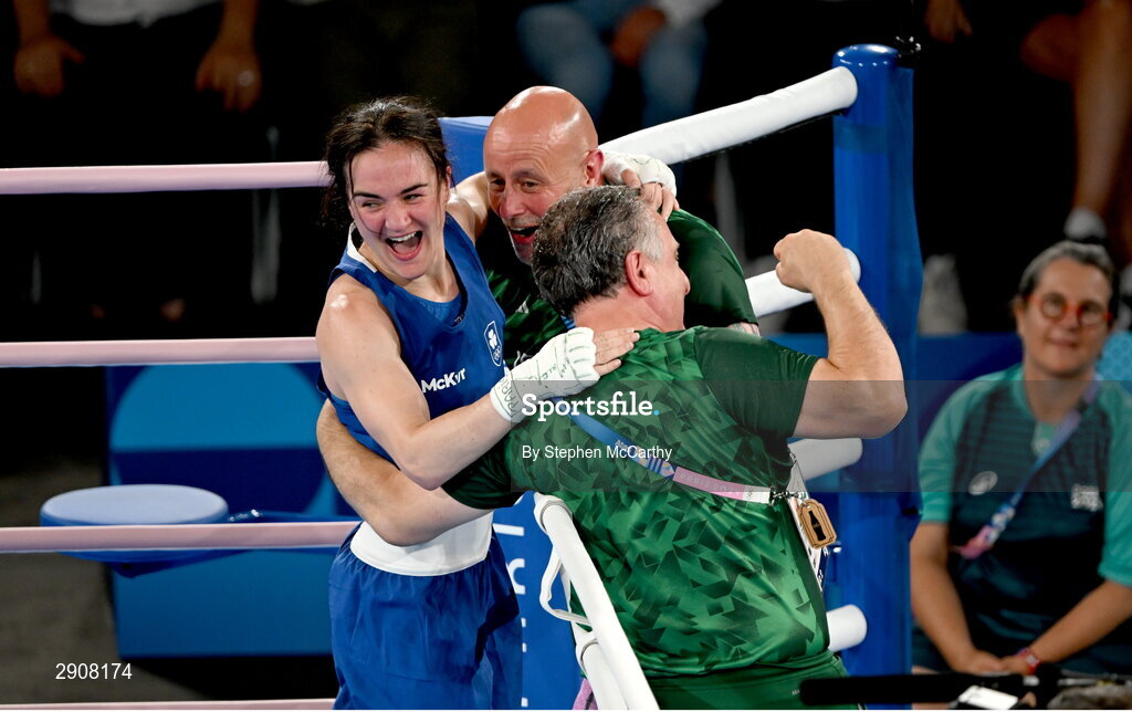 6 August 2024; Kellie Harrington of Team Ireland, left, celebrates with head coach Zaur Antia, right, and Damian Kennedy, centre, after defeating Wenlu Yang of Team People's Republic of China during their women's 60kg final boutat Court Philippe-Chatrier in Roland Garros Stadium during the 2024 Paris Summer Olympic Games in Paris, France. Photo by Stephen McCarthy/Sportsfile