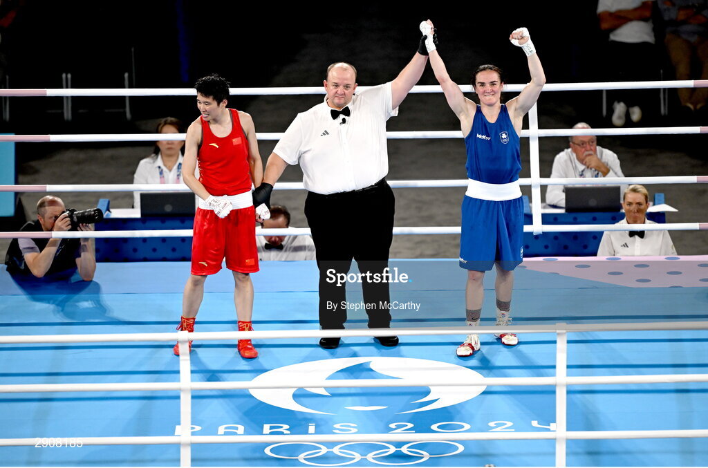 6 August 2024; Kellie Harrington of Team Ireland, right, is declared victorious, by referee Jeffery Verhoeven of Canada, against Wenlu Yang of Team People's Republic of China after their women's 60kg final bout at Court Philippe-Chatrier in Roland Garros Stadium during the 2024 Paris Summer Olympic Games in Paris, France. Photo by Stephen McCarthy/Sportsfile