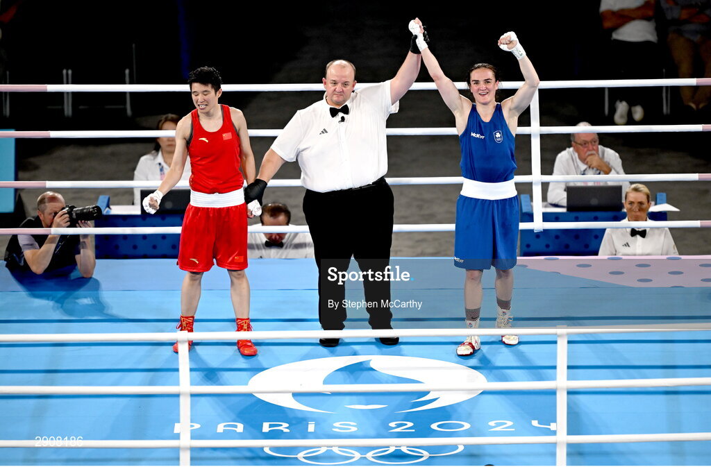 6 August 2024; Kellie Harrington of Team Ireland, right, is declared victorious, by referee Jeffery Verhoeven of Canada, against Wenlu Yang of Team People's Republic of China after their women's 60kg final bout at Court Philippe-Chatrier in Roland Garros Stadium during the 2024 Paris Summer Olympic Games in Paris, France. Photo by Stephen McCarthy/Sportsfile