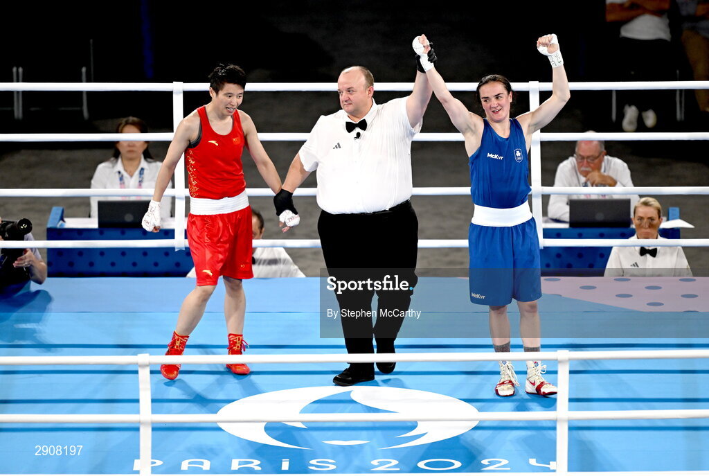 6 August 2024; Kellie Harrington of Team Ireland, right, is declared victorious, by referee Jeffery Verhoeven of Canada, against Wenlu Yang of Team People's Republic of China after their women's 60kg final bout at Court Philippe-Chatrier in Roland Garros Stadium during the 2024 Paris Summer Olympic Games in Paris, France. Photo by Stephen McCarthy/Sportsfile