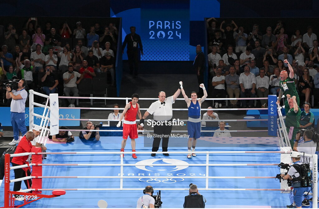 6 August 2024; Kellie Harrington of Team Ireland is declared victorious, by referee Jeffery Verhoeven of Canada, after defeating Wenlu Yang of Team People's Republic of China in their women's 60kg final bout at Court Philippe-Chatrier in Roland Garros Stadium during the 2024 Paris Summer Olympic Games in Paris, France. Photo by Stephen McCarthy/Sportsfile