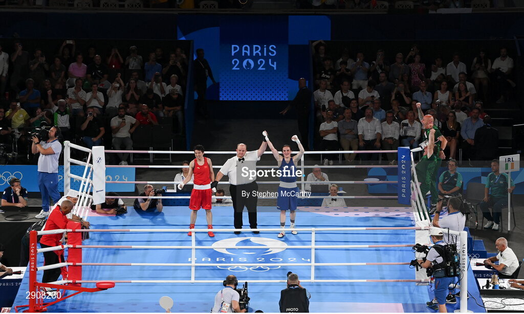 6 August 2024; Kellie Harrington of Team Ireland is declared victorious, by referee Jeffery Verhoeven of Canada, after defeating Wenlu Yang of Team People's Republic of China in their women's 60kg final bout at Court Philippe-Chatrier in Roland Garros Stadium during the 2024 Paris Summer Olympic Games in Paris, France. Photo by Stephen McCarthy/Sportsfile