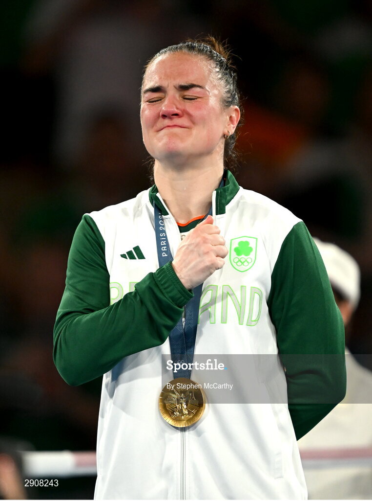 6 August 2024; An emotional Kellie Harrington of Team Ireland during the playing of Amhrán na bhFiann, with her gold medal, after defeating Wenlu Yang of Team People's Republic of China during their women's 60kg final bout at Court Philippe-Chatrier in Roland Garros Stadium during the 2024 Paris Summer Olympic Games in Paris, France. Photo by Stephen McCarthy/Sportsfile
