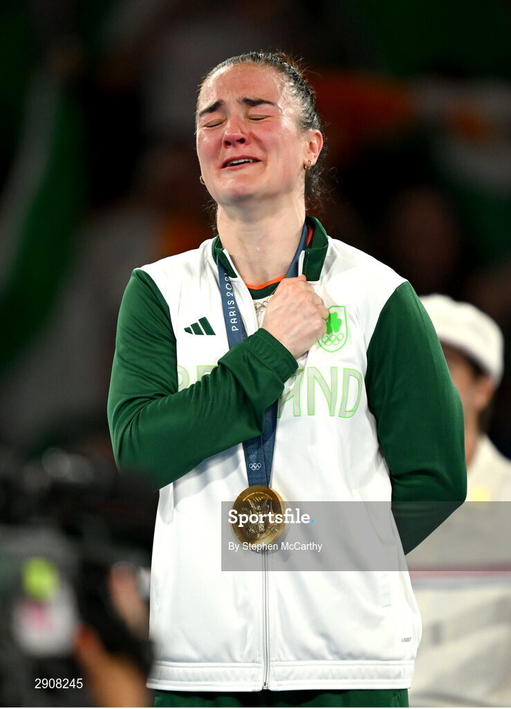 6 August 2024; An emotional Kellie Harrington of Team Ireland during the playing of Amhrán na bhFiann, with her gold medal, after defeating Wenlu Yang of Team People's Republic of China during their women's 60kg final bout at Court Philippe-Chatrier in Roland Garros Stadium during the 2024 Paris Summer Olympic Games in Paris, France. Photo by Stephen McCarthy/Sportsfile