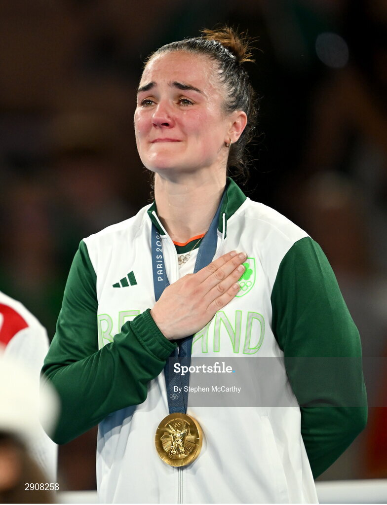 6 August 2024; An emotional Kellie Harrington of Team Ireland during the playing of Amhrán na bhFiann, with her gold medal, after defeating Wenlu Yang of Team People's Republic of China during their women's 60kg final bout at Court Philippe-Chatrier in Roland Garros Stadium during the 2024 Paris Summer Olympic Games in Paris, France. Photo by Stephen McCarthy/Sportsfile