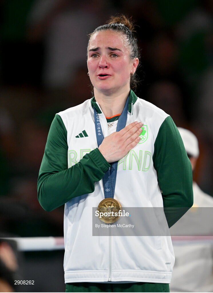6 August 2024; An emotional Kellie Harrington of Team Ireland during the playing of Amhrán na bhFiann, with her gold medal, after defeating Wenlu Yang of Team People's Republic of China during their women's 60kg final bout at Court Philippe-Chatrier in Roland Garros Stadium during the 2024 Paris Summer Olympic Games in Paris, France. Photo by Stephen McCarthy/Sportsfile