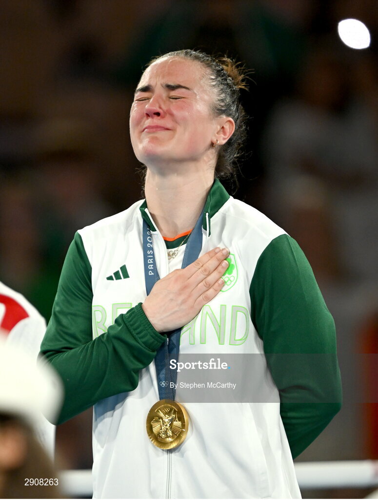 6 August 2024; An emotional Kellie Harrington of Team Ireland during the playing of Amhrán na bhFiann, with her gold medal, after defeating Wenlu Yang of Team People's Republic of China during their women's 60kg final bout at Court Philippe-Chatrier in Roland Garros Stadium during the 2024 Paris Summer Olympic Games in Paris, France. Photo by Stephen McCarthy/Sportsfile