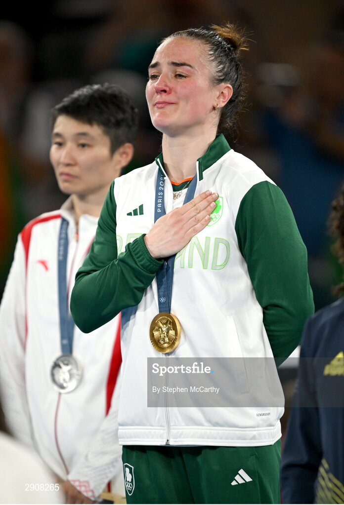 6 August 2024; An emotional Kellie Harrington of Team Ireland during the playing of Amhrán na bhFiann, with her gold medal, after defeating Wenlu Yang of Team People's Republic of China during their women's 60kg final bout at Court Philippe-Chatrier in Roland Garros Stadium during the 2024 Paris Summer Olympic Games in Paris, France. Photo by Stephen McCarthy/Sportsfile