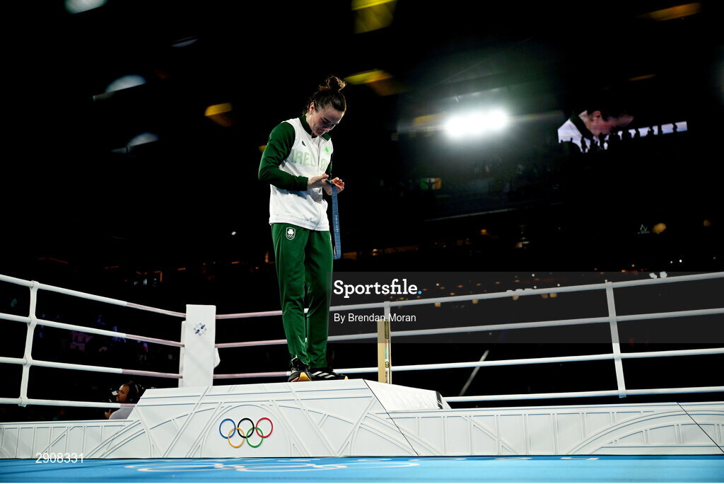 6 August 2024; An emotional Kellie Harrington of Team Ireland looks at her gold medal as she leaves the podium following the medal ceremony after defeating Wenlu Yang of Team People's Republic of China in their women's 60kg final bout at Court Philippe-Chatrier in Roland Garros Stadium during the 2024 Paris Summer Olympic Games in Paris, France. Photo by Brendan Moran/Sportsfile
