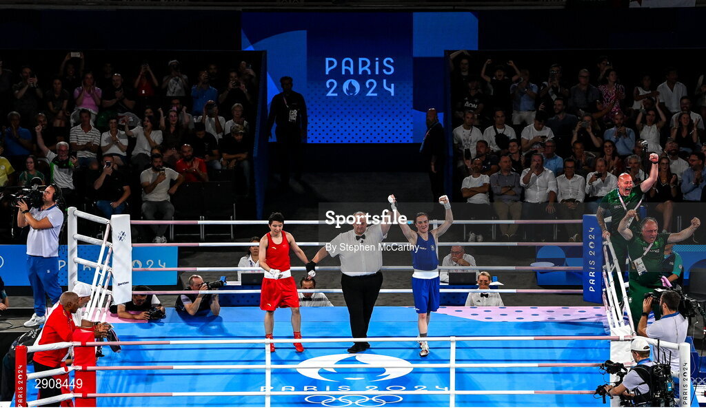 6 August 2024; Kellie Harrington of Team Ireland is declared victorious, by referee Jeffery Verhoeven of Canada, after defeating Wenlu Yang of Team People's Republic of China in their women's 60kg final bout at Court Philippe-Chatrier in Roland Garros Stadium during the 2024 Paris Summer Olympic Games in Paris, France. Photo by Stephen McCarthy/Sportsfile