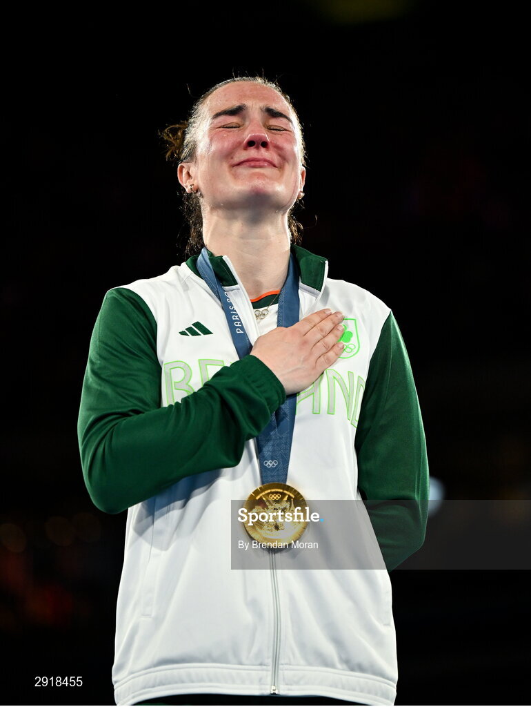 6 August 2024; An emotional Kellie Harrington of Team Ireland stands for Amhrán na bhFiann with her gold medal after defeating Wenlu Yang of Team People's Republic of China in their women's 60kg final bout at Court Philippe-Chatrier in Roland Garros Stadium during the 2024 Paris Summer Olympic Games in Paris, France. Photo by Brendan Moran/Sportsfile