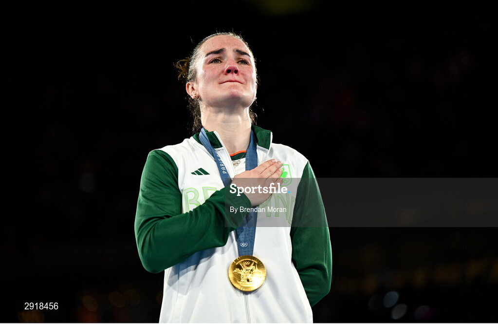 6 August 2024; An emotional Kellie Harrington of Team Ireland stands for Amhrán na bhFiann with her gold medal after defeating Wenlu Yang of Team People's Republic of China in their women's 60kg final bout at Court Philippe-Chatrier in Roland Garros Stadium during the 2024 Paris Summer Olympic Games in Paris, France. Photo by Brendan Moran/Sportsfile