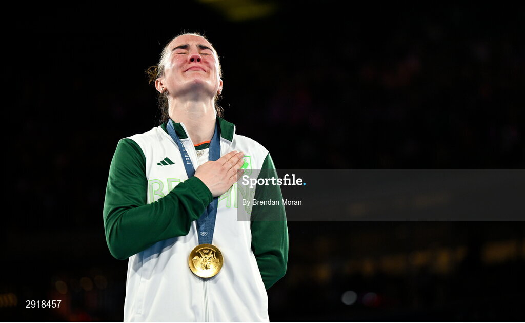 6 August 2024; An emotional Kellie Harrington of Team Ireland stands for Amhrán na bhFiann with her gold medal after defeating Wenlu Yang of Team People's Republic of China in their women's 60kg final bout at Court Philippe-Chatrier in Roland Garros Stadium during the 2024 Paris Summer Olympic Games in Paris, France. Photo by Brendan Moran/Sportsfile