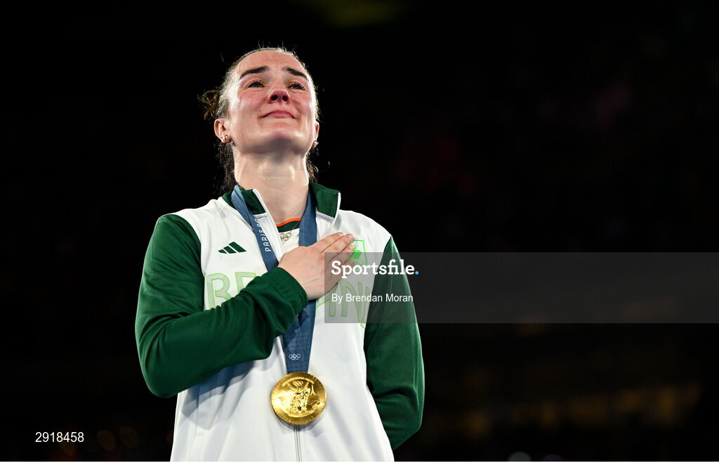 6 August 2024; An emotional Kellie Harrington of Team Ireland stands for Amhrán na bhFiann with her gold medal after defeating Wenlu Yang of Team People's Republic of China in their women's 60kg final bout at Court Philippe-Chatrier in Roland Garros Stadium during the 2024 Paris Summer Olympic Games in Paris, France. Photo by Brendan Moran/Sportsfile