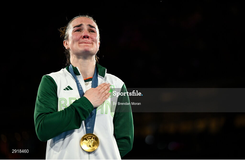 6 August 2024; An emotional Kellie Harrington of Team Ireland stands for Amhrán na bhFiann with her gold medal after defeating Wenlu Yang of Team People's Republic of China in their women's 60kg final bout at Court Philippe-Chatrier in Roland Garros Stadium during the 2024 Paris Summer Olympic Games in Paris, France. Photo by Brendan Moran/Sportsfile