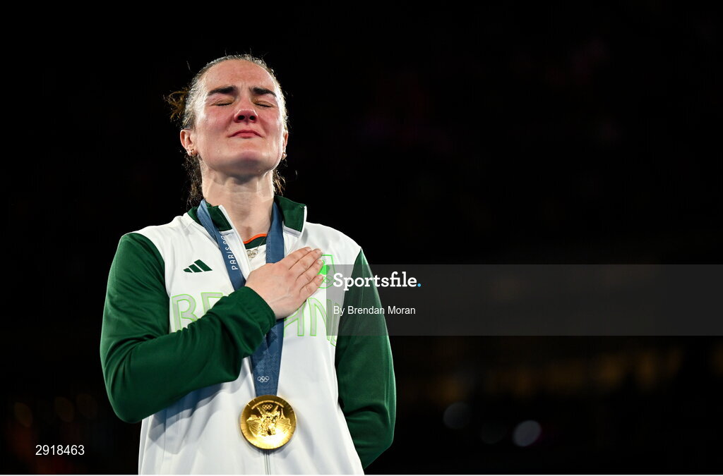 6 August 2024; An emotional Kellie Harrington of Team Ireland stands for Amhrán na bhFiann with her gold medal after defeating Wenlu Yang of Team People's Republic of China in their women's 60kg final bout at Court Philippe-Chatrier in Roland Garros Stadium during the 2024 Paris Summer Olympic Games in Paris, France. Photo by Brendan Moran/Sportsfile