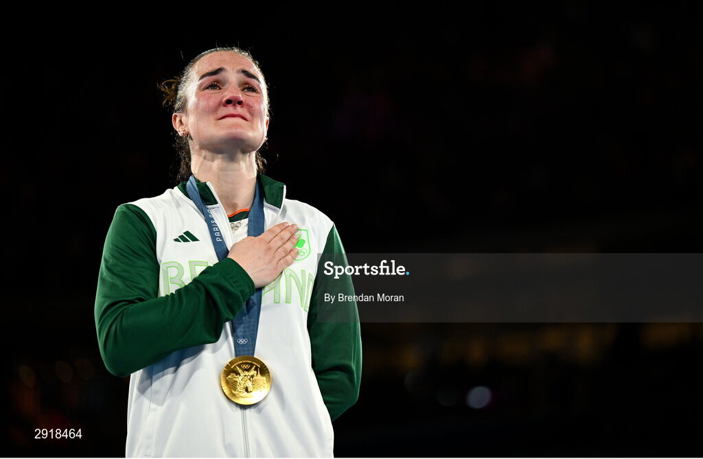 6 August 2024; An emotional Kellie Harrington of Team Ireland stands for Amhrán na bhFiann with her gold medal after defeating Wenlu Yang of Team People's Republic of China in their women's 60kg final bout at Court Philippe-Chatrier in Roland Garros Stadium during the 2024 Paris Summer Olympic Games in Paris, France. Photo by Brendan Moran/Sportsfile