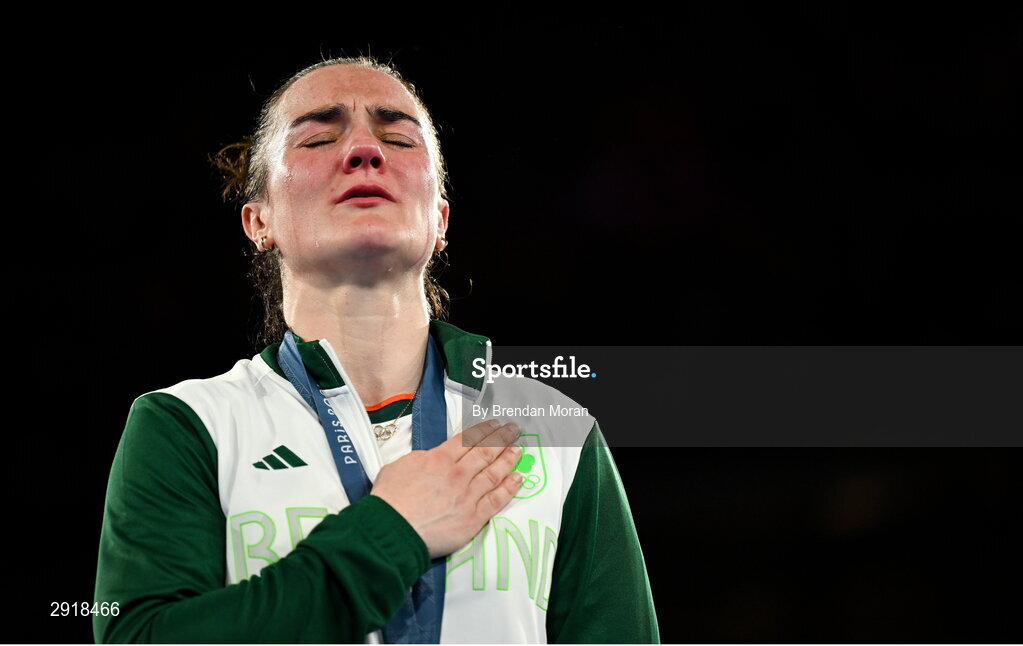 6 August 2024; An emotional Kellie Harrington of Team Ireland stands for Amhrán na bhFiann with her gold medal after defeating Wenlu Yang of Team People's Republic of China in their women's 60kg final bout at Court Philippe-Chatrier in Roland Garros Stadium during the 2024 Paris Summer Olympic Games in Paris, France. Photo by Brendan Moran/Sportsfile