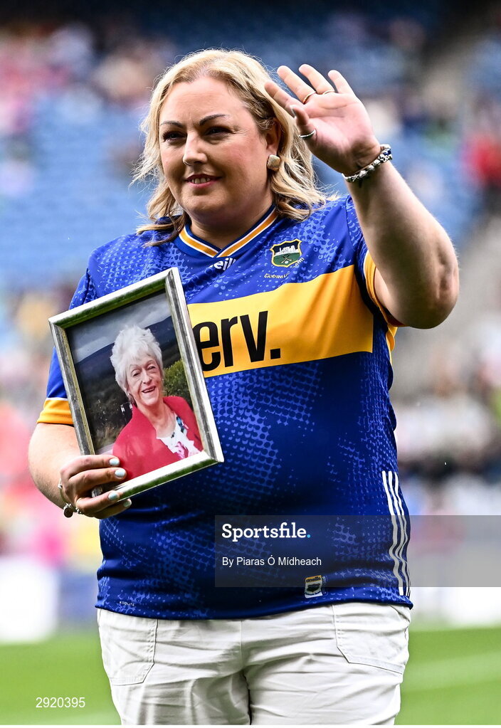 4 August 2024; Elaine Byrne, representing her late mother Nora Moran from Newcastle of the Tipperary team of 1974, who won the first All-Ireland Ladies Senior Football Championship final as they are introduced to the crowd at half-time during the TG4 All-Ireland Ladies Football Intermediate Championship final match between Leitrim and Tyrone at Croke Park in Dublin. Photo by Piaras Ó Mídheach/Sportsfile