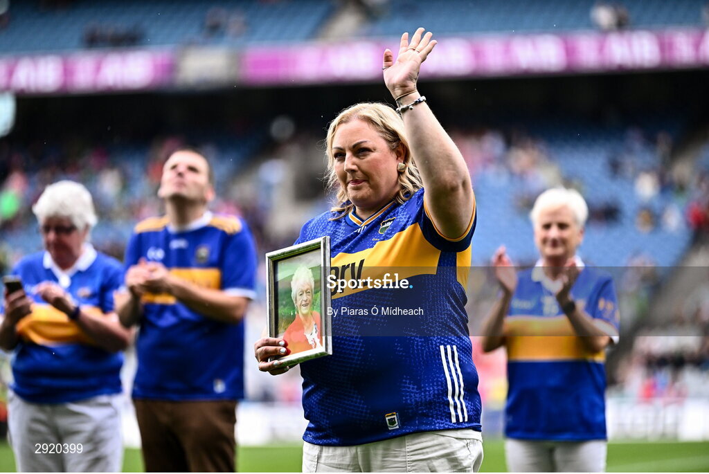 4 August 2024; Elaine Byrne, representing her late mother Nora Moran from Newcastle of the Tipperary team of 1974, who won the first All-Ireland Ladies Senior Football Championship final as they are introduced to the crowd at half-time during the TG4 All-Ireland Ladies Football Intermediate Championship final match between Leitrim and Tyrone at Croke Park in Dublin. Photo by Piaras Ó Mídheach/Sportsfile