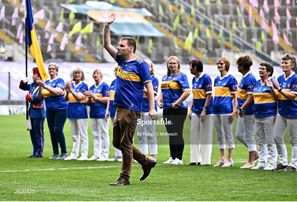 4 August 2024; Colm McGrath, representing his sister Mary McGrath from Emly of the Tipperary team of 1974, who won the first All-Ireland Ladies Senior Football Championship final, as they are introduced to the crowd at half-time during the TG4 All-Ireland Ladies Football Intermediate Championship final match between Leitrim and Tyrone at Croke Park in Dublin. Photo by Piaras Ó Mídheach/Sportsfile