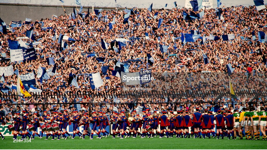 22 September 1985; Dublin supporters on Hill 16 cheer as the Artane Boys Band lead the teams in the pre-match parade before the All Ireland Football Championship Final match between Kerry and Dublin at Croke Park, Dublin. Photo by Ray McManus/Sportsfile