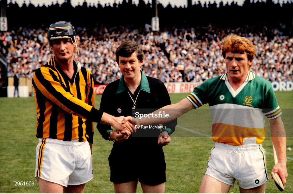 25 July 1982; Kilkenny captain Brian Cody, left, shakes hands with Offaly captain Pat Carroll, in the company of the referee John Denton, before the Leinster Senior Hurling Championship Final match between Kilkenny and Offaly at Croke Park in Dublin. Photo by Ray McManus/Sportsfile