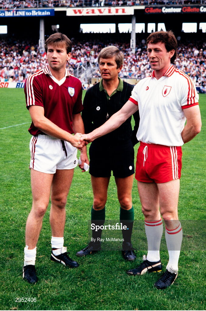 17 August 1986; Galway captain Tomas Tierney shakes hands with Tyrone captain Eugene McKenna in the company of referee Paddy Collins before the All-Ireland Senior Football Championship Semi-Final match between Tyrone and Galway at Croke Park in Dublin. Photo by Ray McManus/Sportsfile