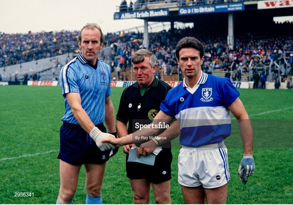 28 July 1985; Dublin captain Brian Mullins shakes hands with Laois captain Colm Browne, in the company of referee Paddy Kavanagh, before the Leinster Senior Football Championship Final match between Dublin and Laois at Croke Park in Dublin. Photo by Ray McManus/Sportsfile