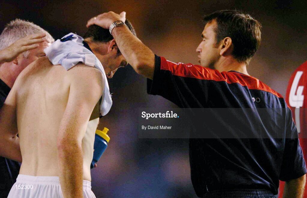 24 August 2004; A dejected Jason Byrne, Shelbourne. with his manager Pat Fenlon, right, and assistant Eamon Collins, after defeat to Deportivo La Coruna at the end of the game. UEFA Champions League, 3rd Round Second Leg Qualifier, Deportivo La Coruna v Shelbourne, Riazor stadium. La Coruna, Spain. Picture credit; David Maher / SPORTSFILE