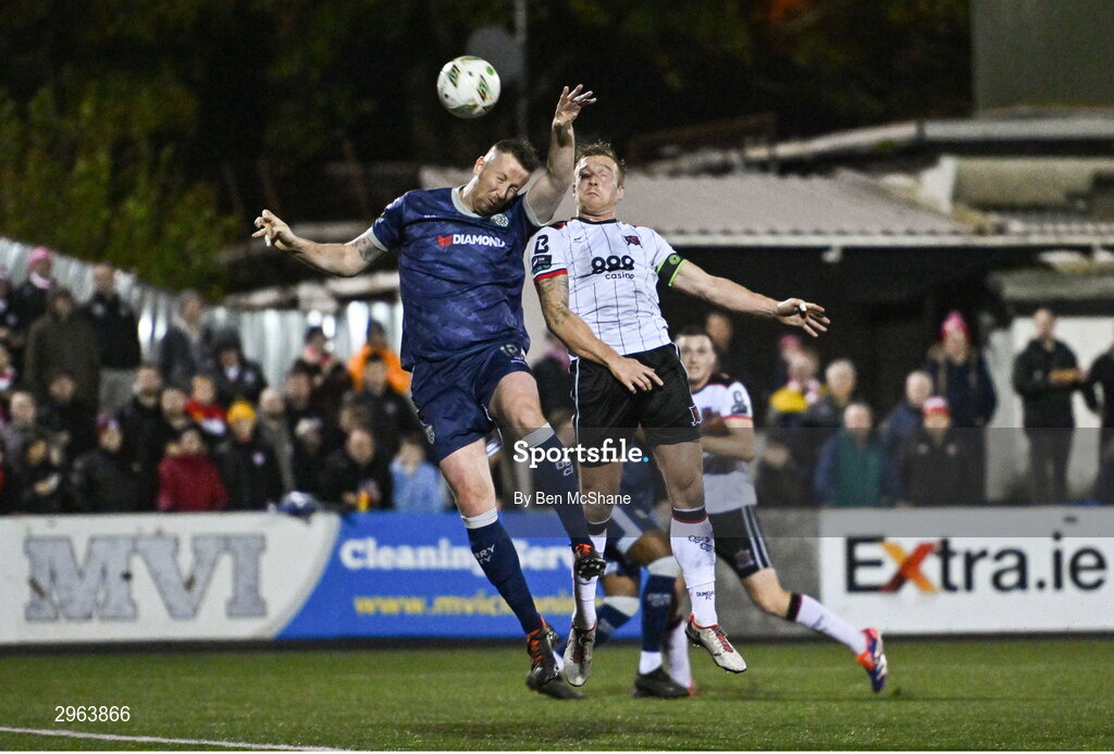 18 October 2024; John Mountney of Dundalk has a header on goal despite the attention of Shane McEleney of Derry City during the SSE Airtricity Men's Premier Division match between Dundalk and Derry City at Oriel Park in Dundalk, Louth. Photo by Ben McShane/Sportsfile