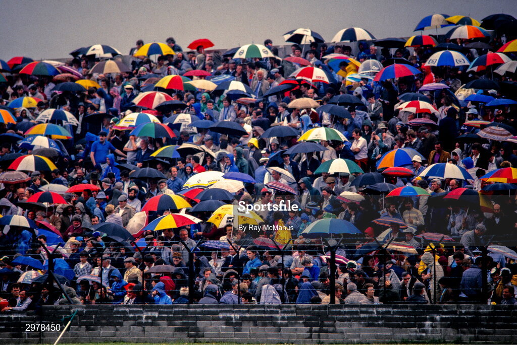 29 June 1986; Supporters covering from the rain during the Leinster Senior Football Championship Semi-final match between Dublin and Offaly in O'Moore Park in Portlaoise, Laois. Photo by Ray McManus/Sportsfile