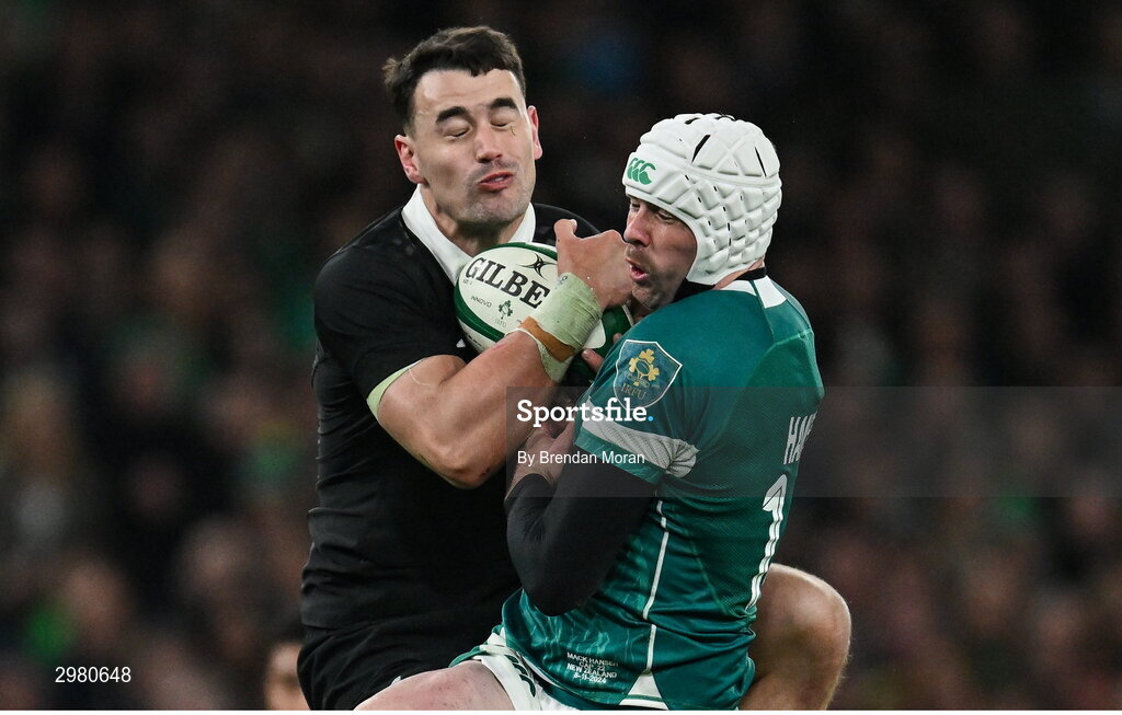 8 November 2024; Will Jordan of New Zealand and Mack Hansen of Ireland contest a high ball during the Autumn Nations Series match between Ireland and New Zealand at the Aviva Stadium in Dublin. Photo by Brendan Moran/Sportsfile