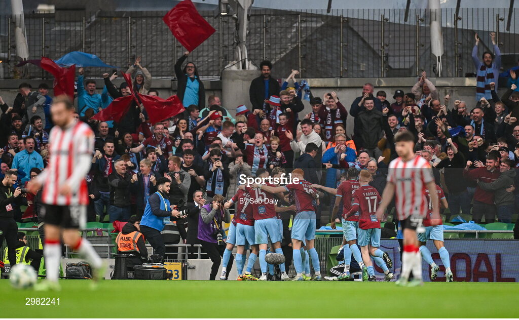 10 November 2024; Andrew Quinn of Drogheda United, centre, celebrates with teammates and supporters after scoring their side's first goal during the Sports Direct Men's FAI Cup Final match between Drogheda United and Derry City at the Aviva Stadium in Dublin. Photo by Seb Daly/Sportsfile