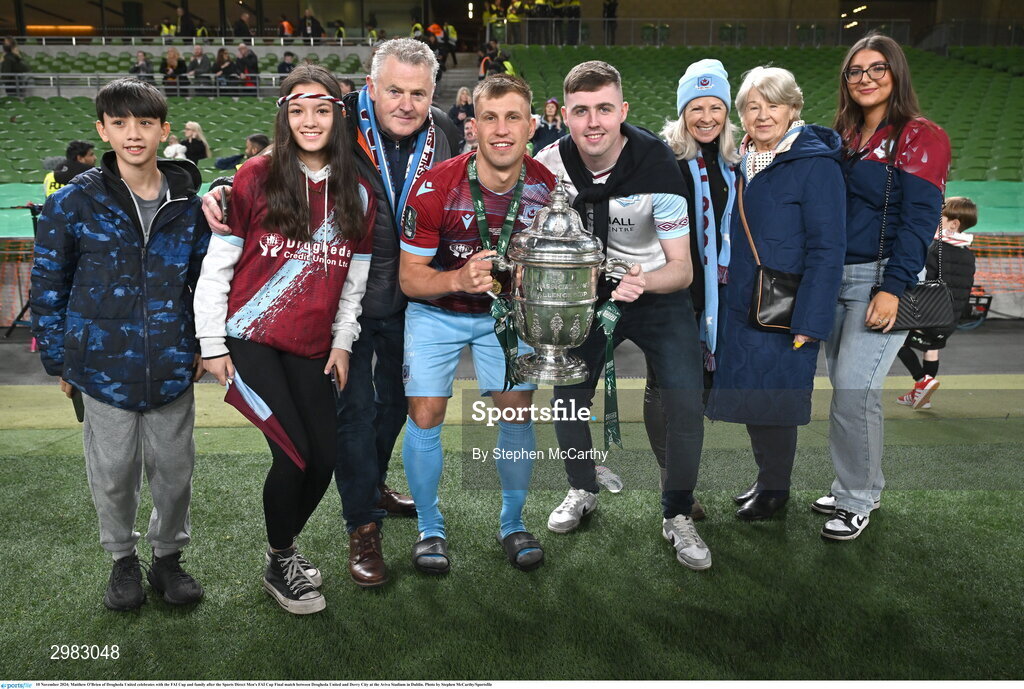 10 November 2024; Matthew O'Brien of Drogheda United celebrates with the FAI Cup and family after the Sports Direct Men's FAI Cup Final match between Drogheda United and Derry City at the Aviva Stadium in Dublin. Photo by Stephen McCarthy/Sportsfile