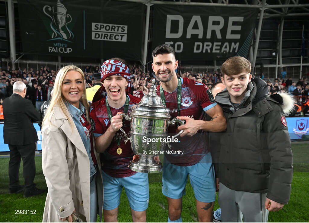 10 November 2024; Warren Davis and Adam Foley of Drogheda United celebrate with the FAI Cup and family after the Sports Direct Men's FAI Cup Final match between Drogheda United and Derry City at the Aviva Stadium in Dublin. Photo by Stephen McCarthy/Sportsfile