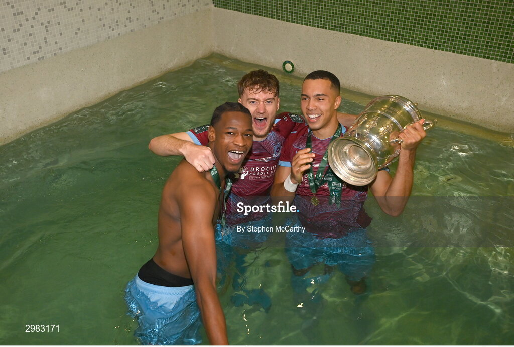 10 November 2024; Drogheda United players, from left, Elicha Ahui, Andrew Quinn and Douglas James-Taylor celebrate with the FAI Cup after the Sports Direct Men's FAI Cup Final match between Drogheda United and Derry City at the Aviva Stadium in Dublin. Photo by Stephen McCarthy/Sportsfile