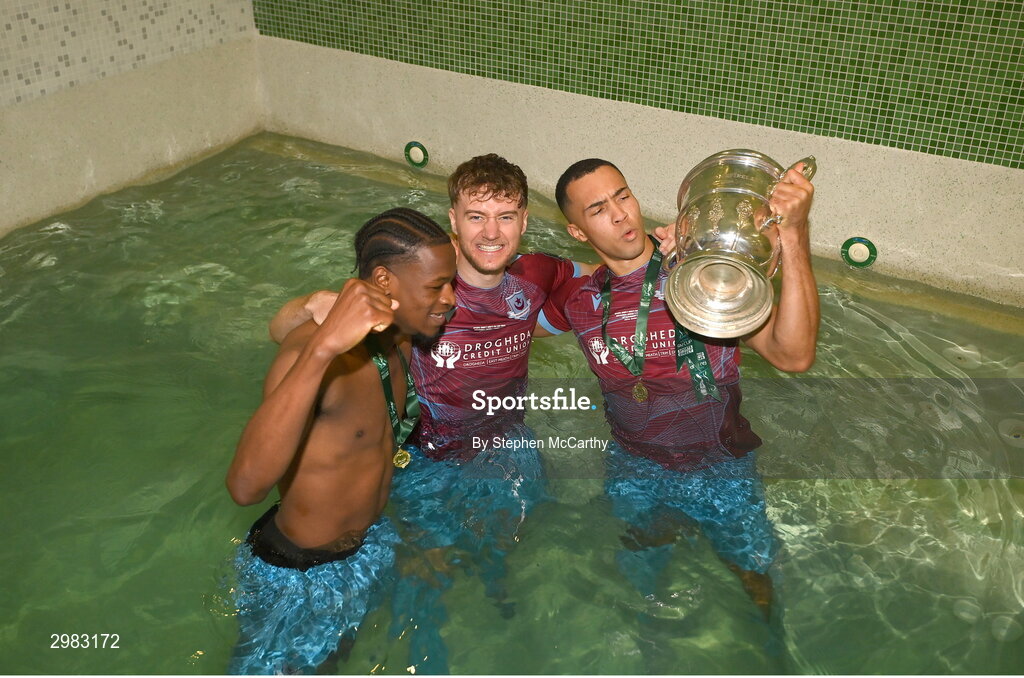 10 November 2024; Drogheda United players, from left, Elicha Ahui, Andrew Quinn and Douglas James-Taylor celebrate with the FAI Cup after the Sports Direct Men's FAI Cup Final match between Drogheda United and Derry City at the Aviva Stadium in Dublin. Photo by Stephen McCarthy/Sportsfile