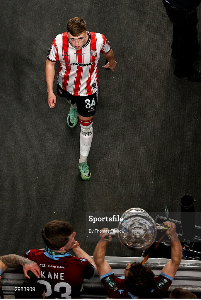 10 November 2024; Callum Doherty of Derry City leaves the pitch as Drogheda United players celebrate with the FAI cup after the Sports Direct Men's FAI Cup Final match between Drogheda United and Derry City at the Aviva Stadium in Dublin. Photo by Thomas Flinkow/Sportsfile